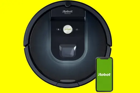 Robot aspirador Roomba 981 negro junto a un smartphone con pantalla verde.