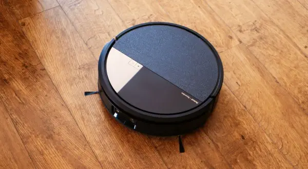 Robot aspirador Roomba con tecnología dirt detect, listo para limpiar el suelo de madera.