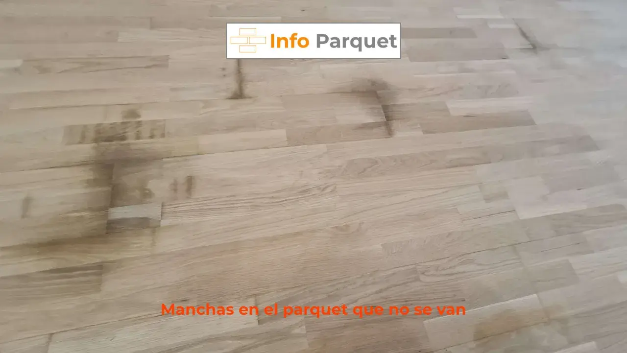 Manchas oscuras y persistentes en el parquet de madera clara, un problema común que requiere solución.