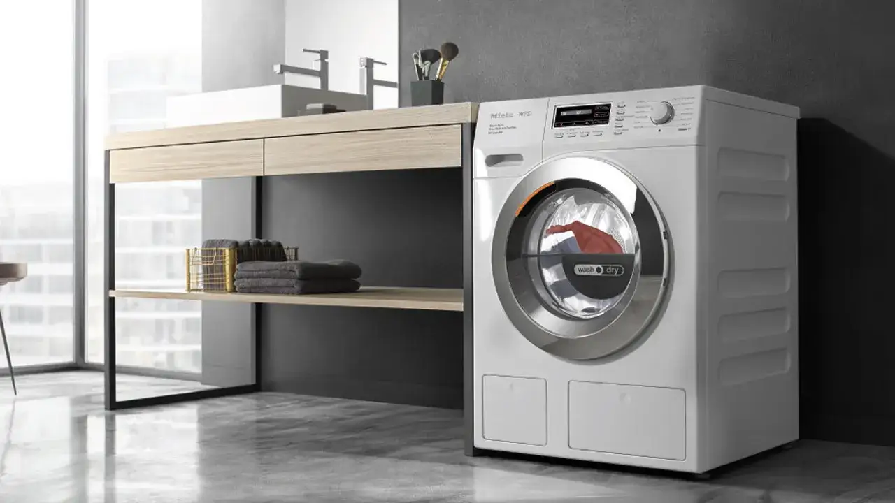 Lavadora Miele con ropa dentro, parece que la secadora no seca bien.