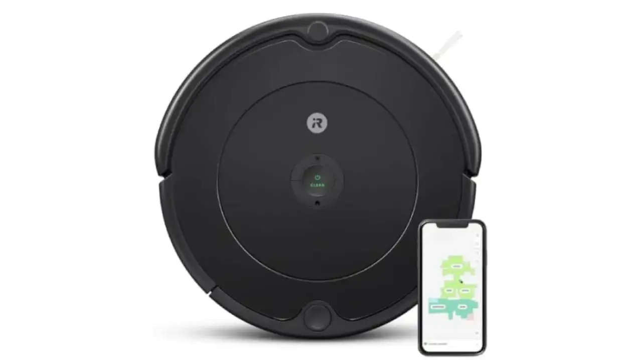 Robot aspirador Roomba 981 negro junto a un smartphone mostrando un mapa de limpieza.