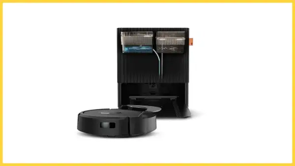 Robot aspirador negro junto a su base de carga, que incluye depósitos de agua y suciedad, creando una zona de exclusión para el polvo.